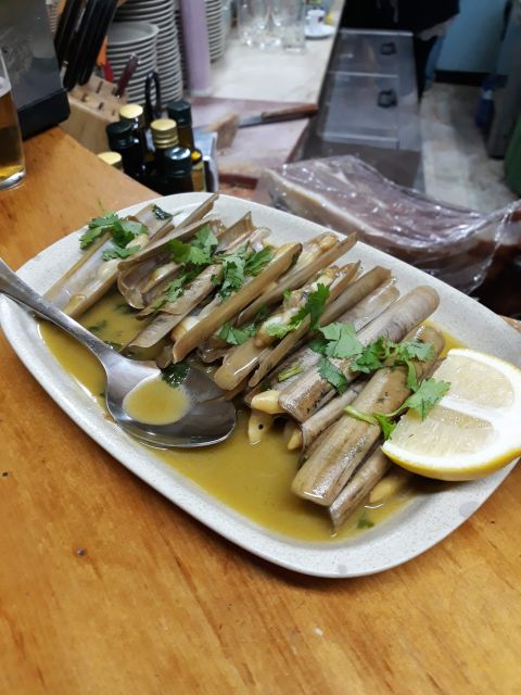 Faro: Old Town Guided Walking Food Tour - Stops two and three: seafood, pork, and changing atmospheres