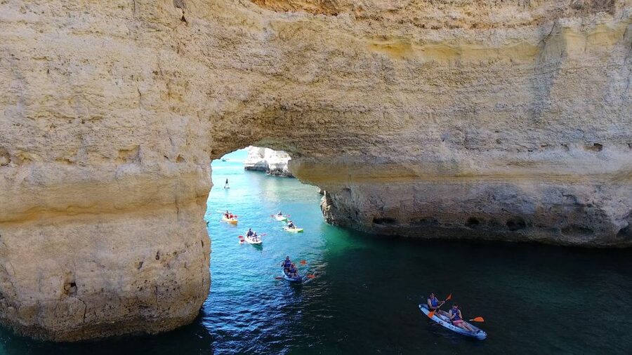 From Albufeira: Benagil Hidden Caves Tour by Kayak - Returning to the boat for a sea swim