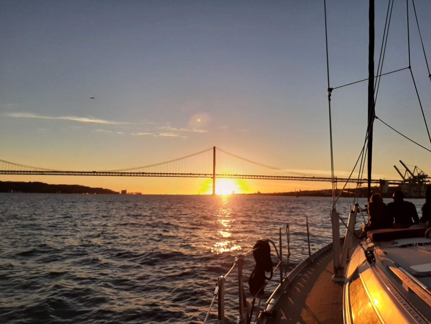 Lisbon: City Skyline Sailboat Cruise with Drink and Snacks - Under the 25 de Abril Bridge toward Praça do Comércio