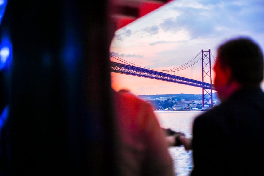 Lisbon: Disco Night Cruise with DJ and Open Bar - Passing beneath the 25 de Abril Bridge