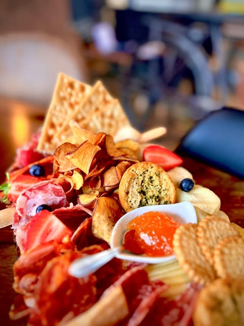 Lisbon: Premium Wine and Tapas Tasting Session - A board built around cheese, sausage, and ham