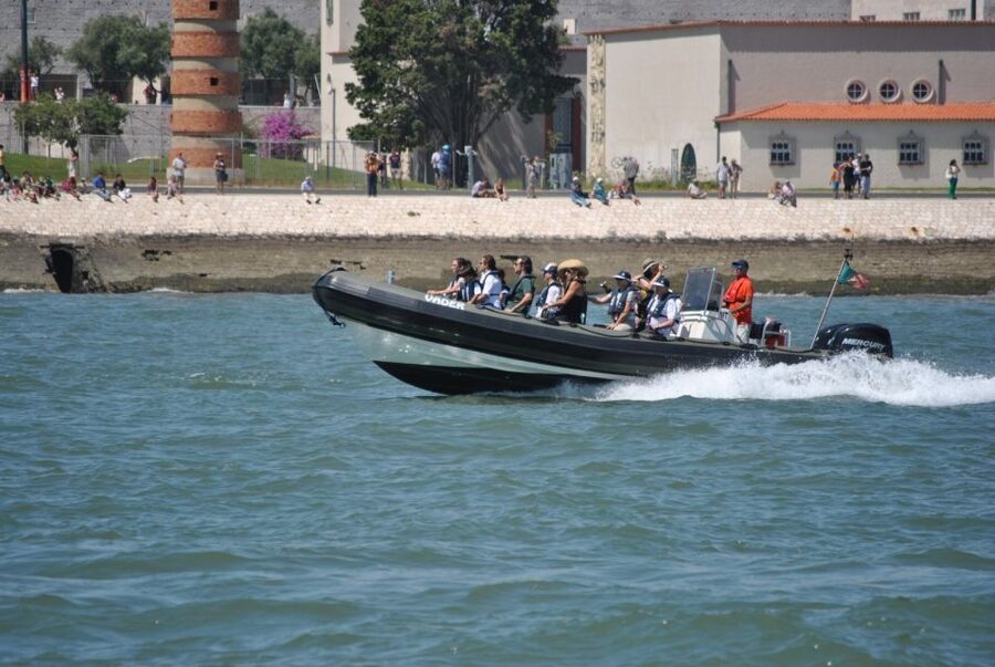 Lisbon: Sunset SpeedBoat Tour - Racing beneath the bridge toward central Lisbon