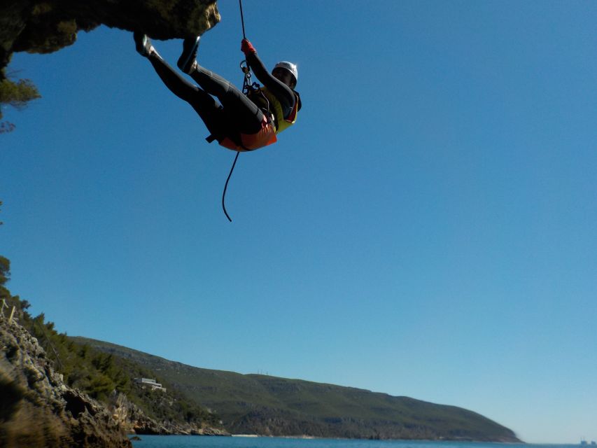 Portinho da Arrábida: Coasteering Boat Tour - Handrail climbing along the rock